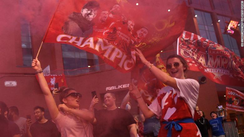Fans outside Anfield, celebrating Liverpool's historic win.