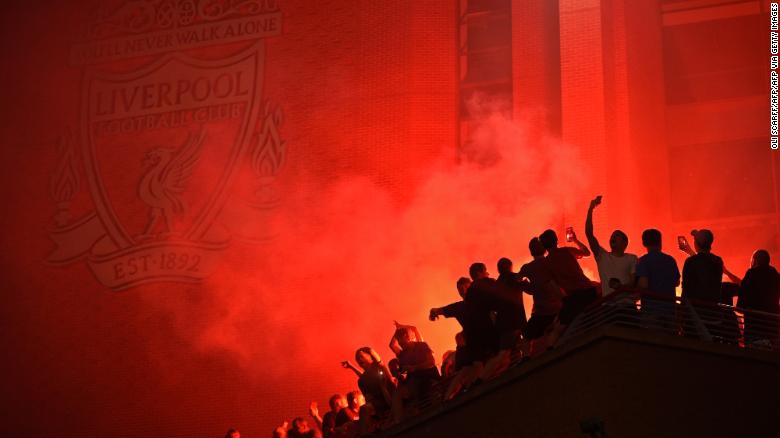 Fans outside Anfield, celebrating Liverpool's historic win.